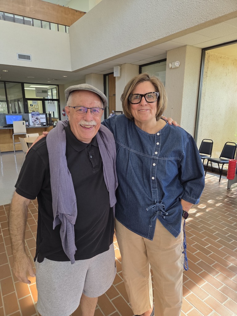 Two Western Texas College employees smile together in the campus lobby during Welcome Back activities.