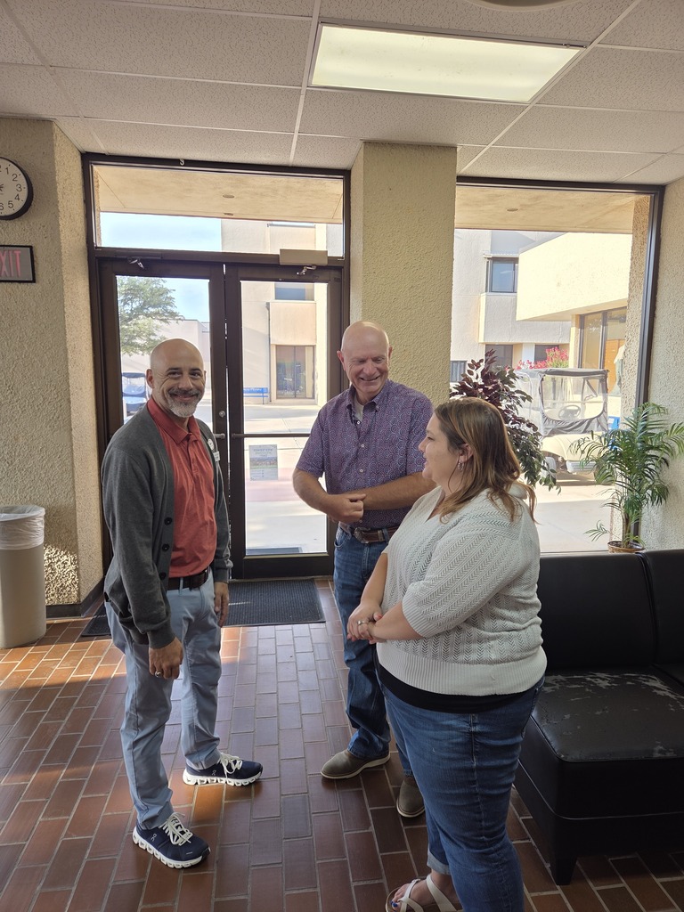 Three Western Texas College employees visit together in the campus lobby before Welcome Back events.