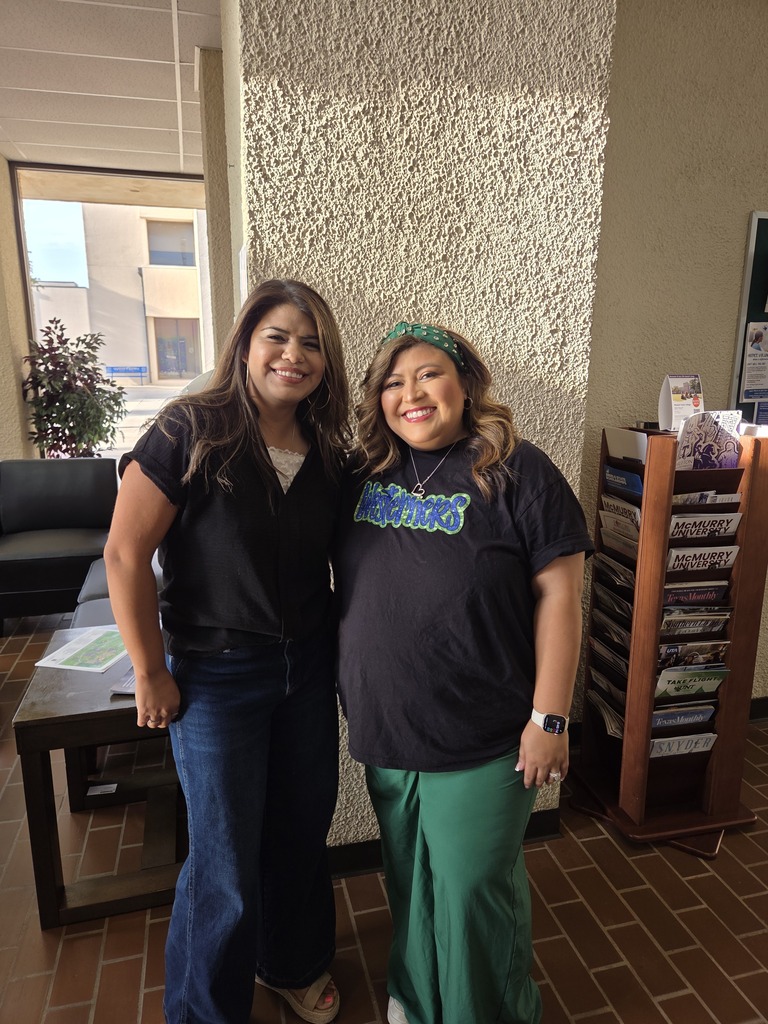 Two Western Texas College employees smile together in the campus lobby during Welcome Back activities.