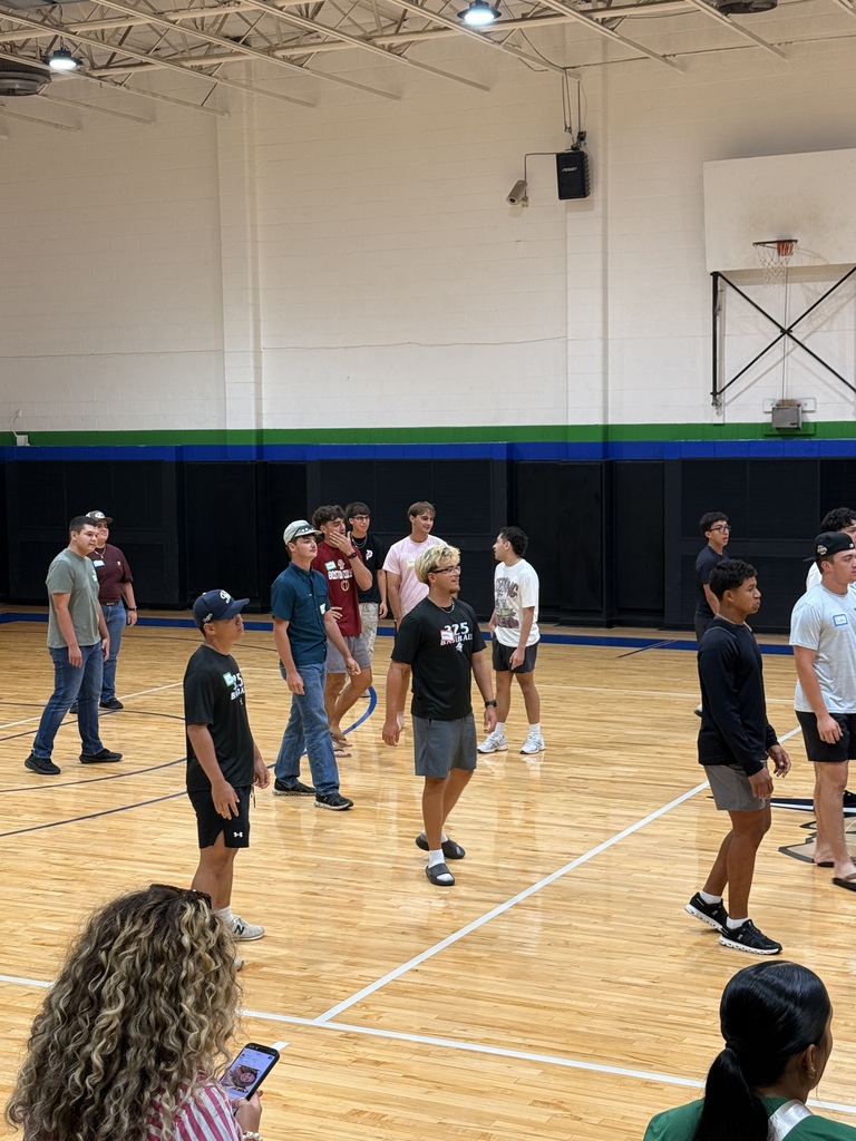 Students participate in a group activity on the gym floor at Western Texas College.