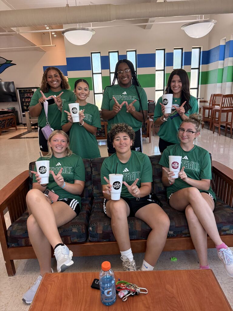WTC softball players pose with drinks inside the Student Commons during Westerner Welcome Day.