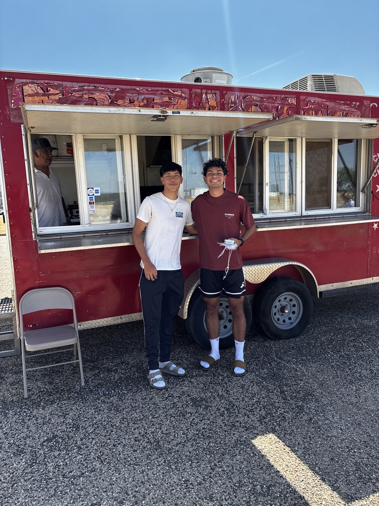 Two WTC students pose together in front of a food truck during Westerner Welcome Day.
