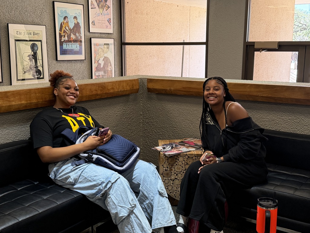 Two WTC students smile while sitting together.