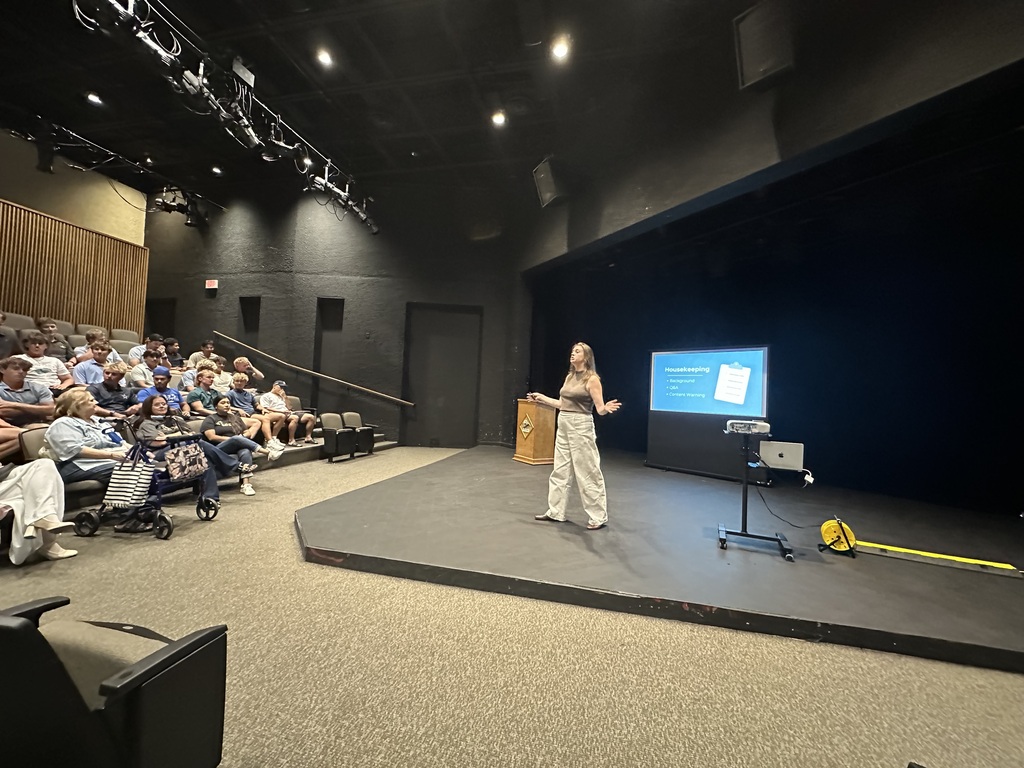 A presenter discusses digital safety with attendees during a community presentation in the WTC Fine Arts Theater.