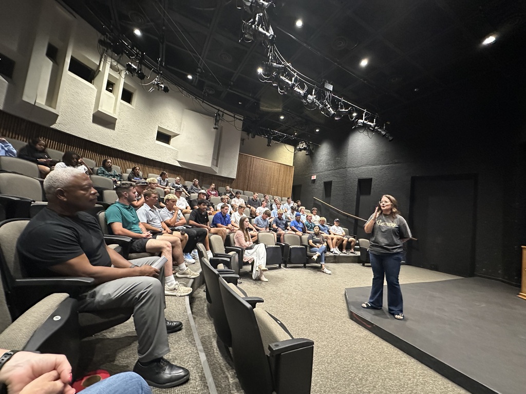 A presenter speaks to attendees in the WTC Fine Arts Theater during an Emerging Issues in Digital Safety event.