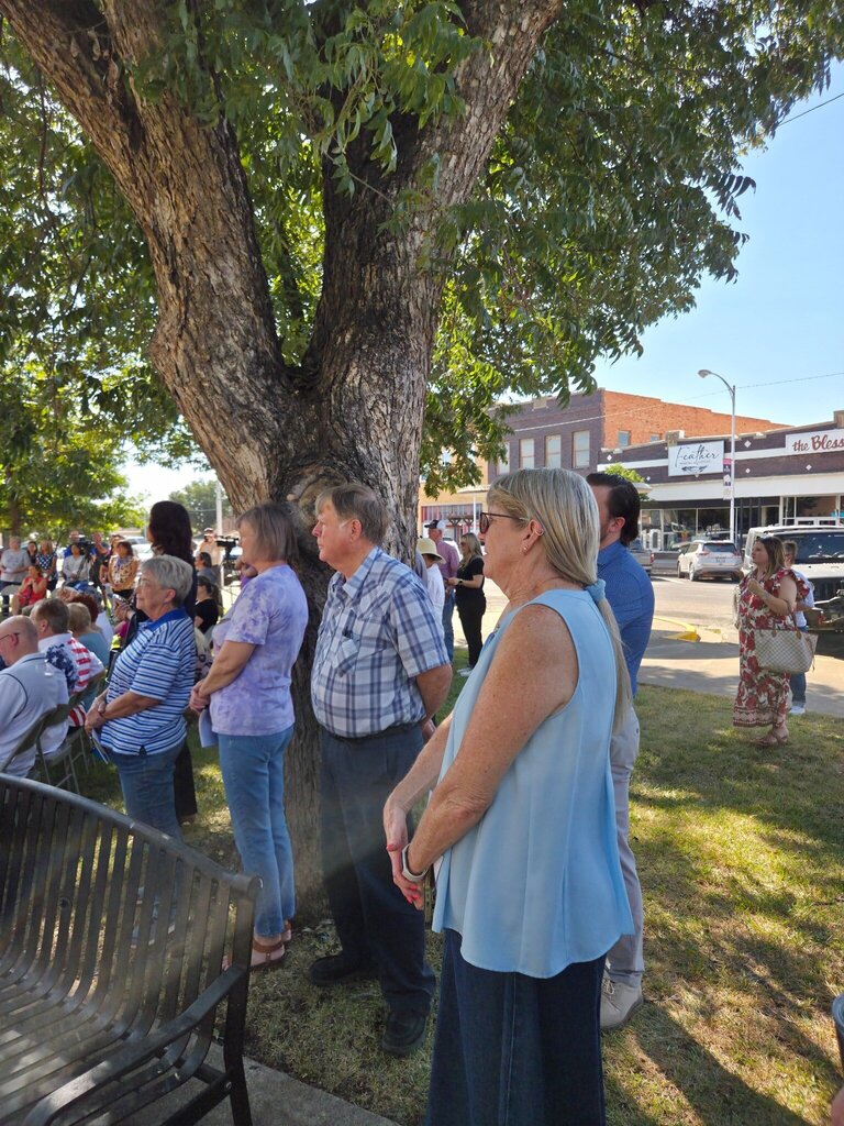 Community members listen to speakers during an outdoor Scurry County 150th anniversary ceremony.