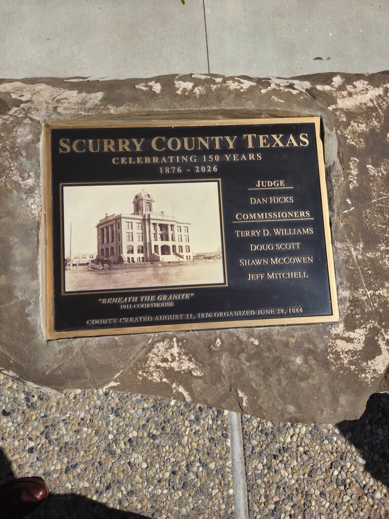 A commemorative plaque marks Scurry County's 150th anniversary, celebrating its history from 1876 to 2026.