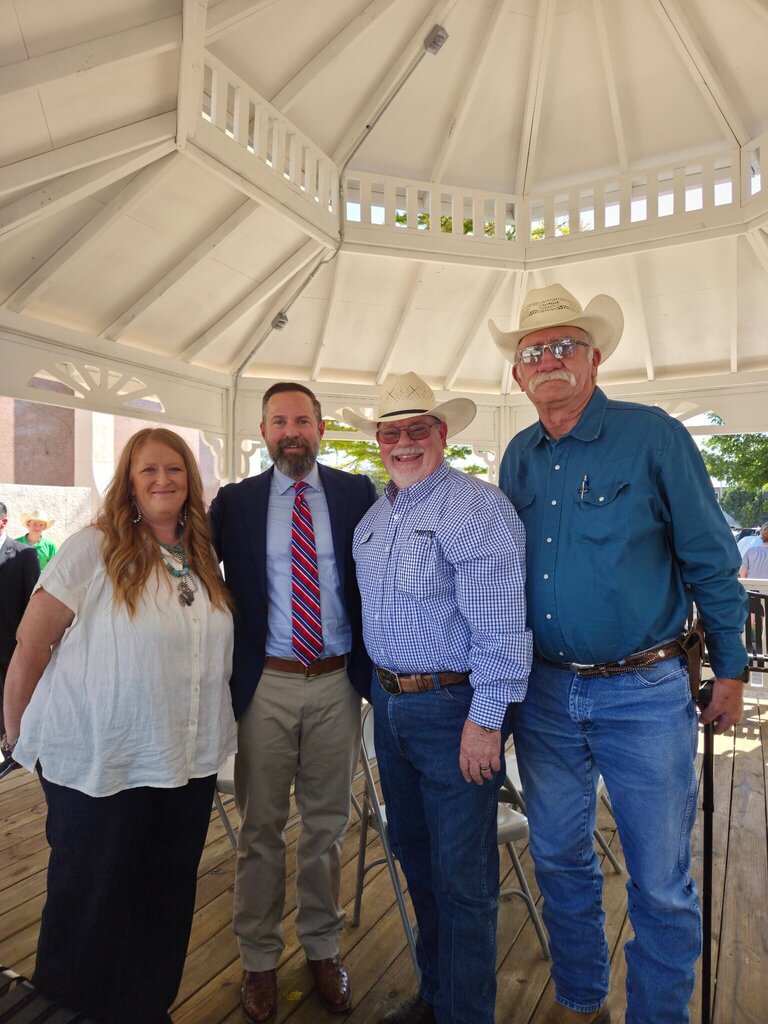 Four community leaders pose together inside the gazebo following the Scurry County 150th anniversary ceremony.