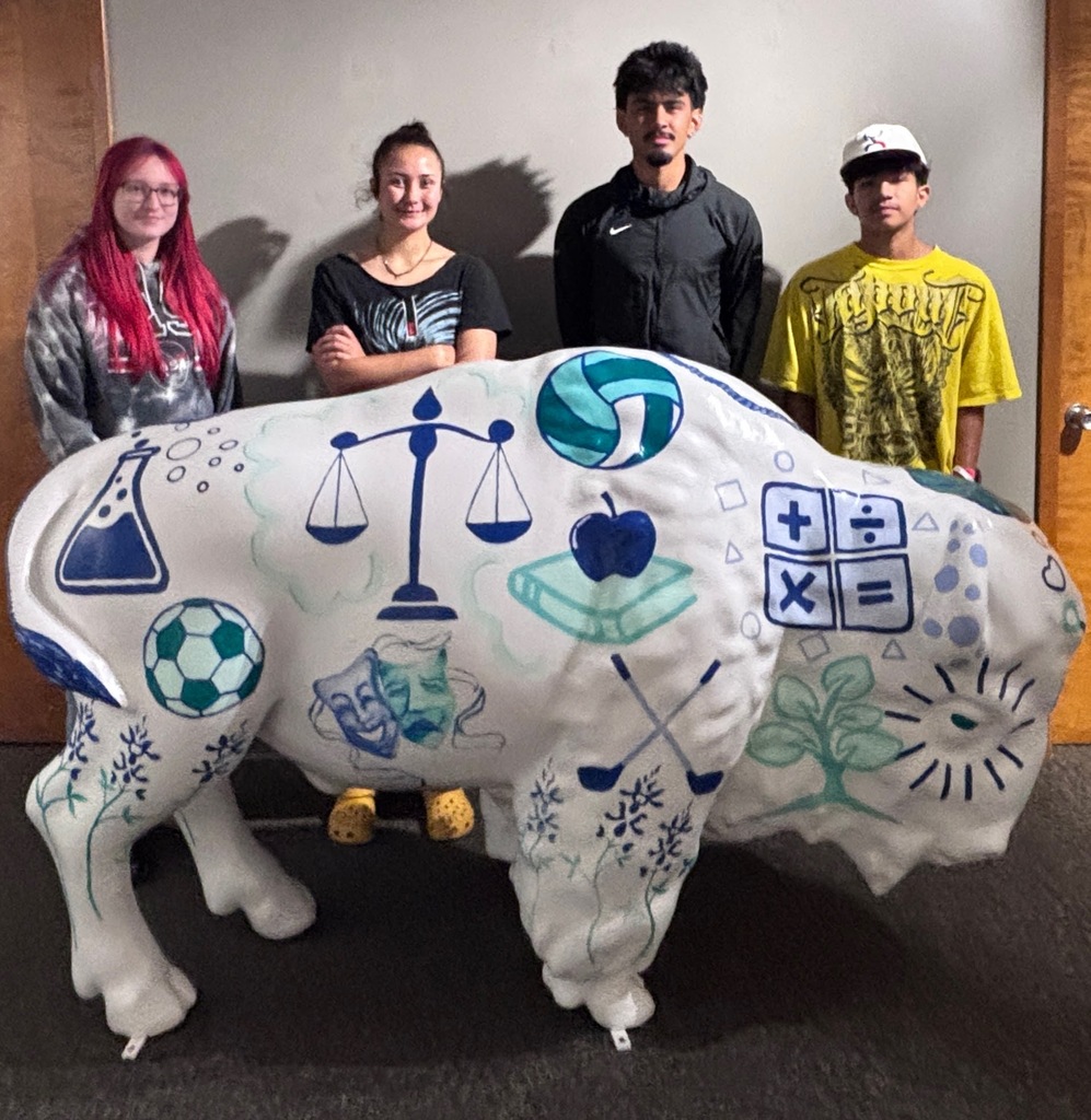 Students pose behind the white buffalo.
