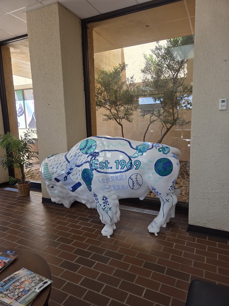 The white buffalo sculpture stands next to a window in the Student Center.