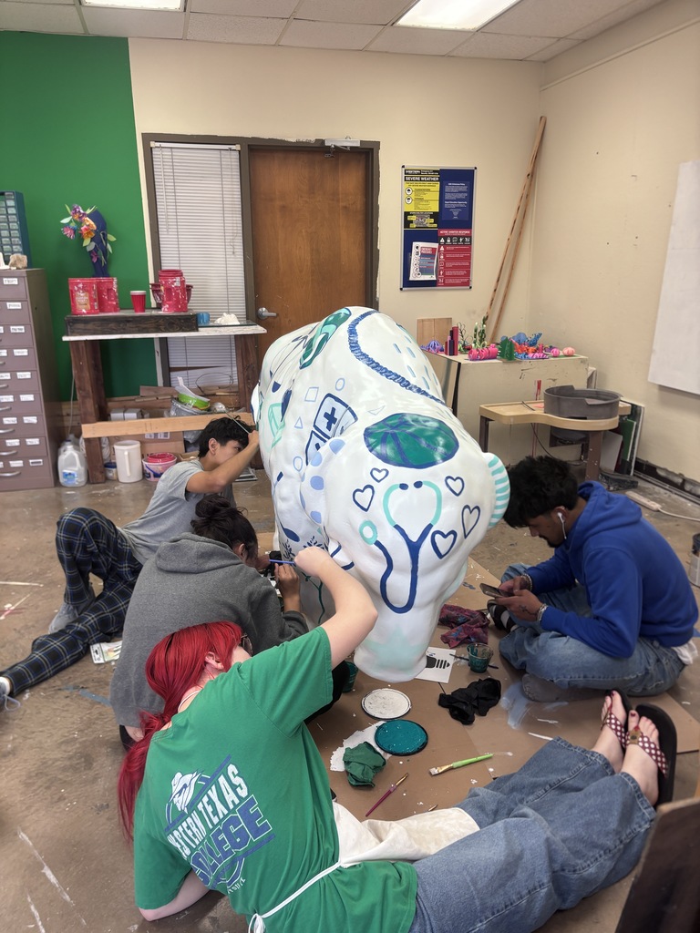 Students paint the white buffalo in the art studio.