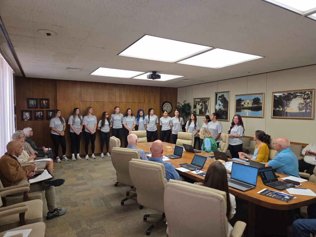 WTC volleyball student-athletes stand before the Board of Trustees during a campus meeting.