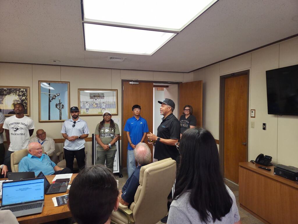 The Cross Country and Track and Field Coach addresses the Board.