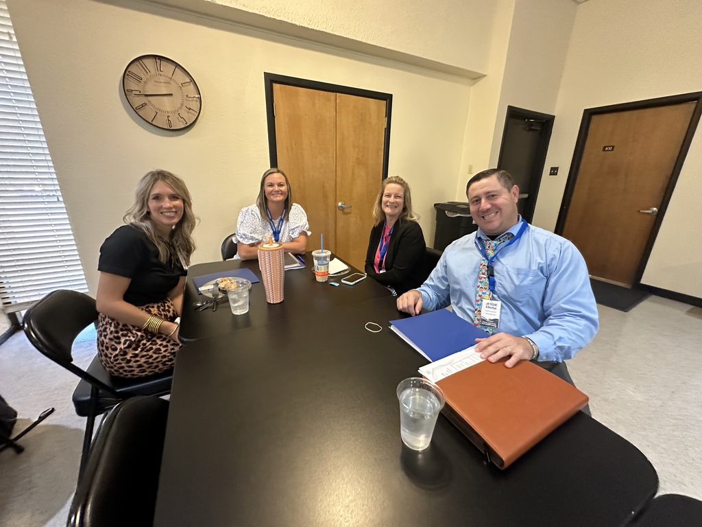 Four attendees sit together at a table during the 2026 Annual Education Partnership Summit.