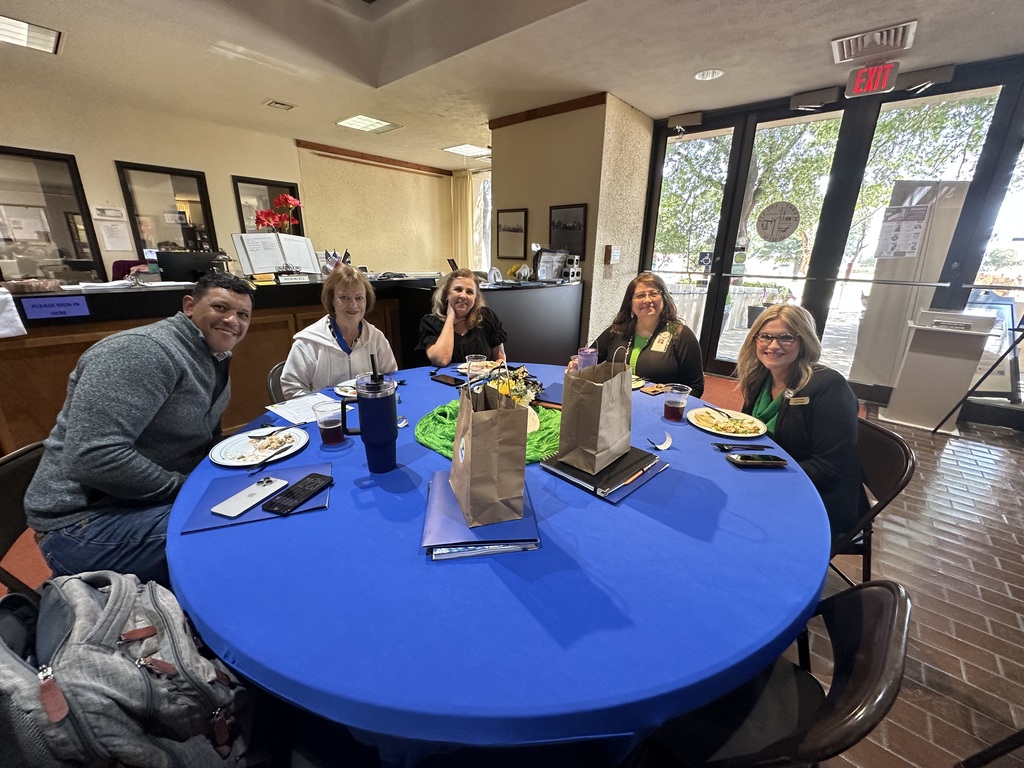 Five attendees smile around a table during the 2026 Annual Education Partnership Summit.