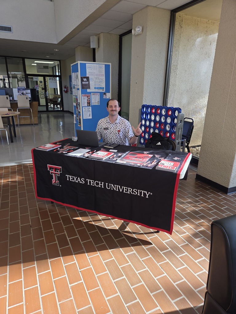 A Texas Tech University representative sits at an information table on the Western Texas College campus.