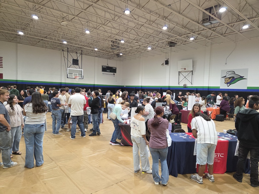 A large crowd of students visits college and university information tables throughout the WTC gym during the Western Texas College College Fair.