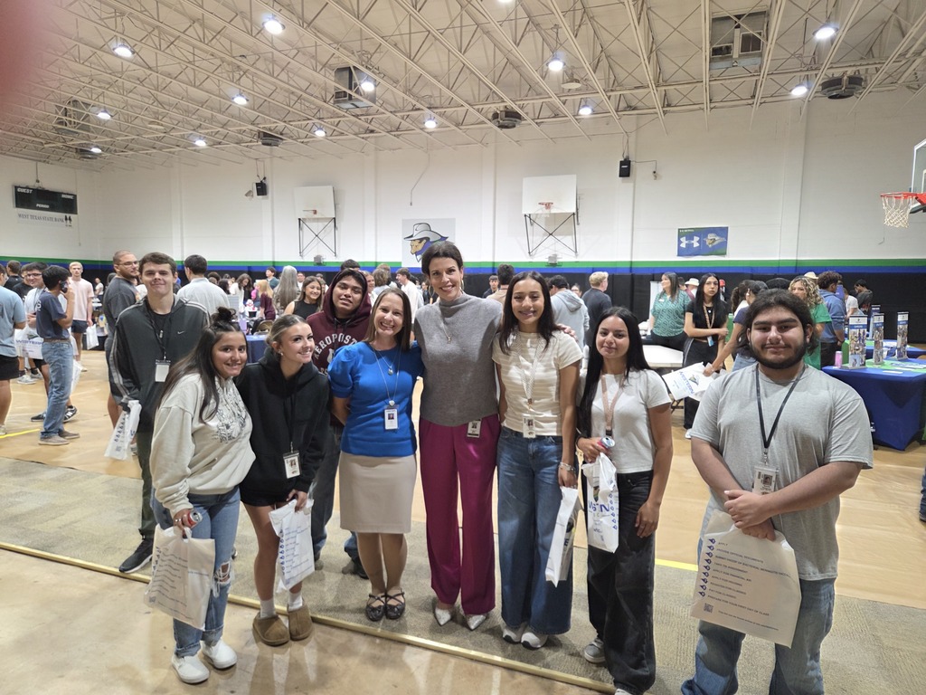 Dr. Sharp and Dr. Gore pose with Snyder High School students at the Western Texas College Fair in the Westerner Gym.