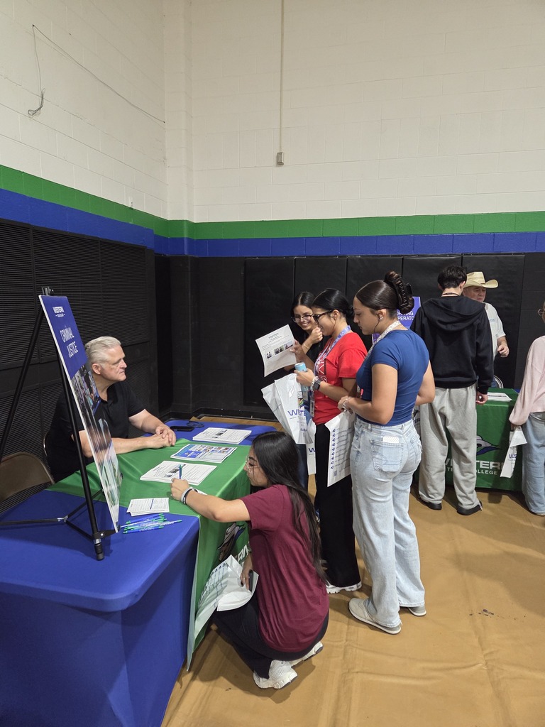 Students gather at a Western Texas College information table to learn about programs and opportunities during the WTC College Fair.
