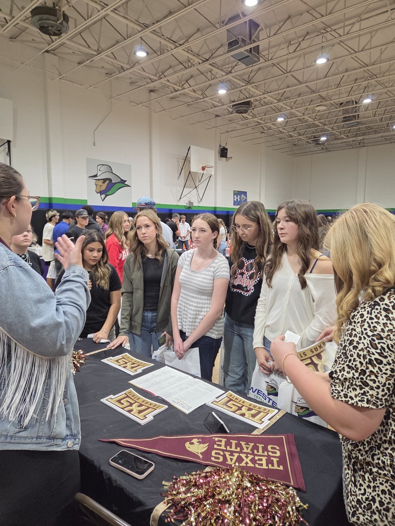 Students gather around a Texas State University information table and listen to a representative during the WTC College Fair.