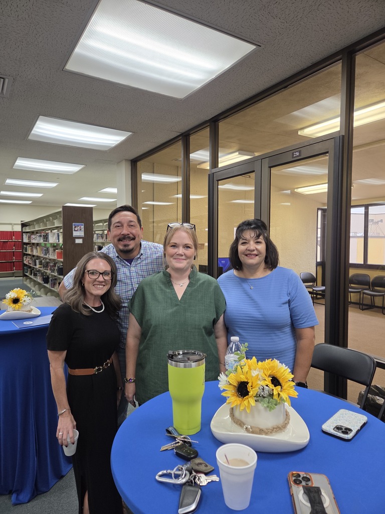 The Snyder Chamber of Commerce team poses together around a decorated table during Coffee with the Chamber at WTC.
