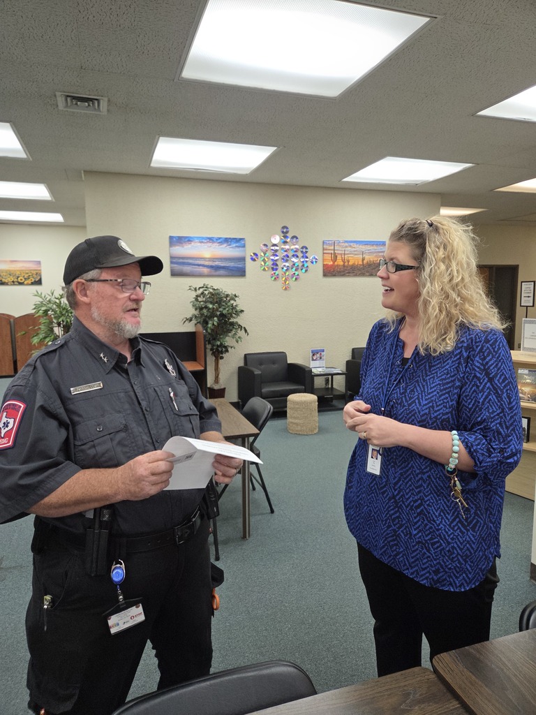 A local first responder talks with a WTC employee during Coffee with the Chamber.
