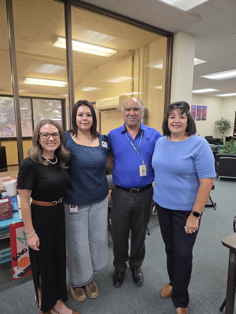 Four people pose together during Coffee with the Chamber in the WTC Resource Center.