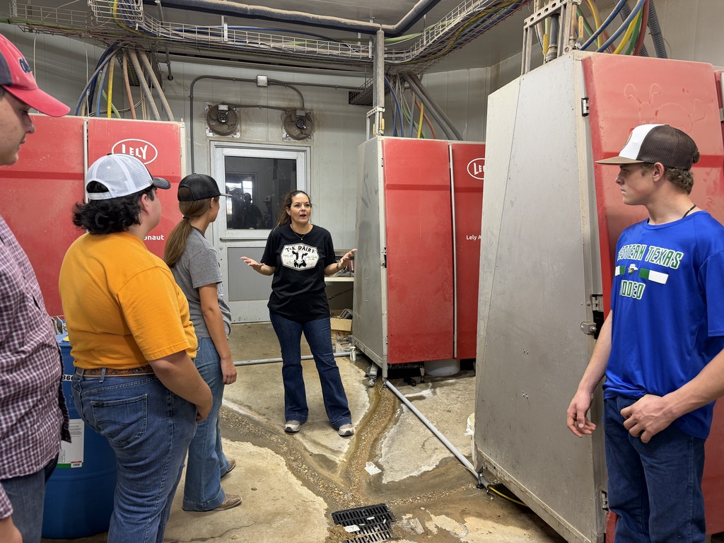 Western Texas College students learn about automated dairy milking equipment during a farm tour.