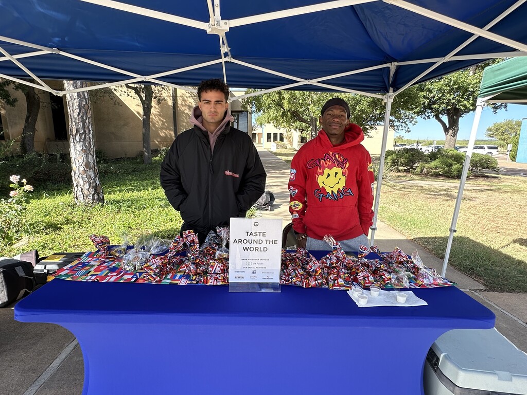 Two students man the international candy table.