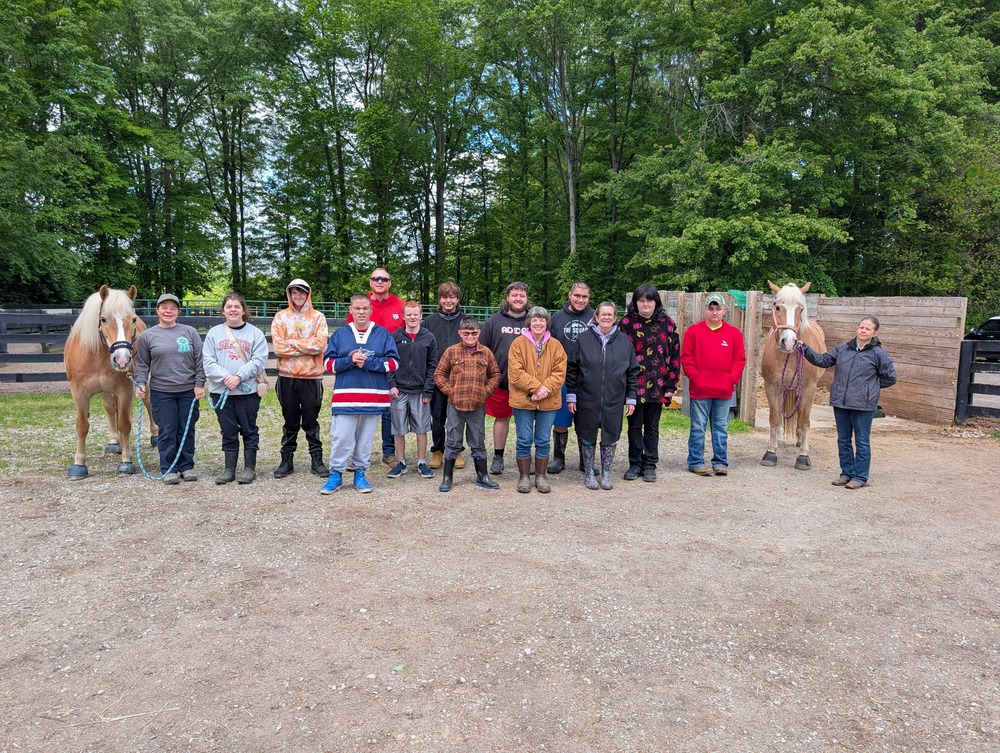 Students standing outside with horses
