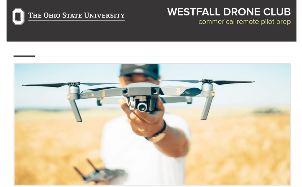 Young man holding a drone in front of camera