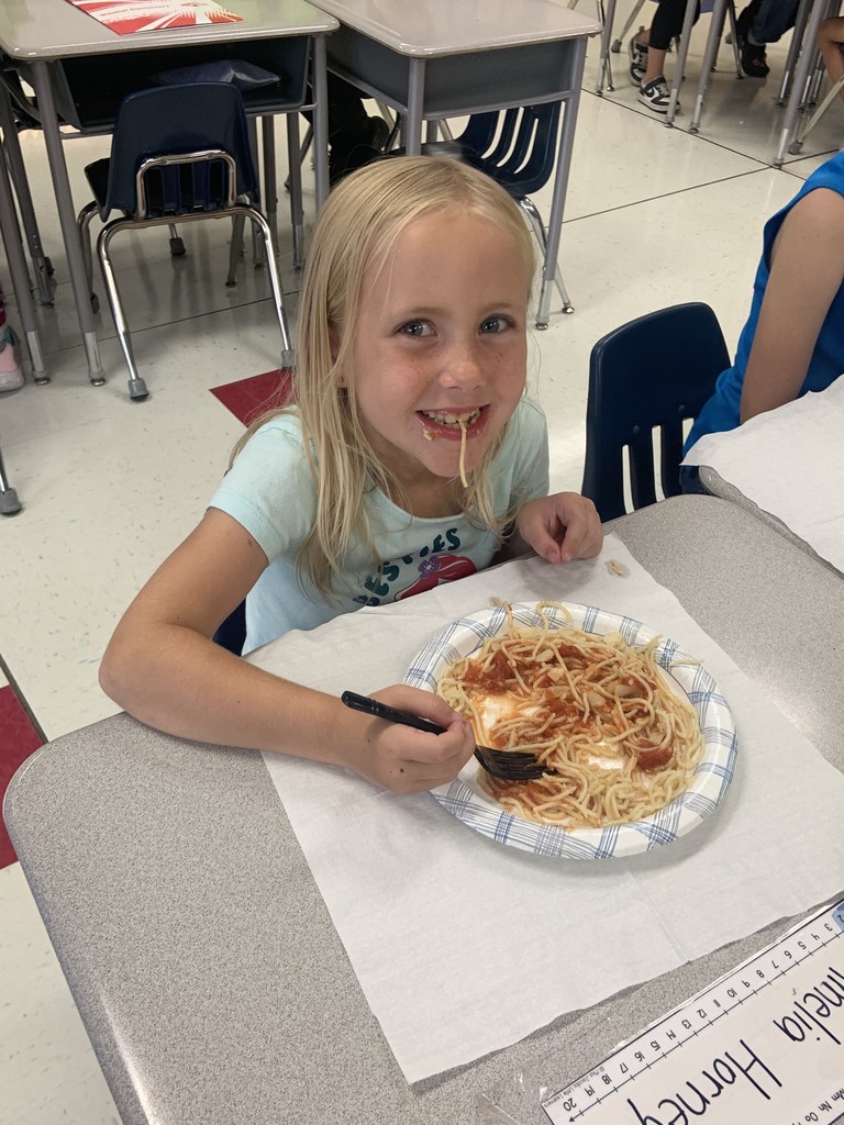 Student enjoying spaghetti