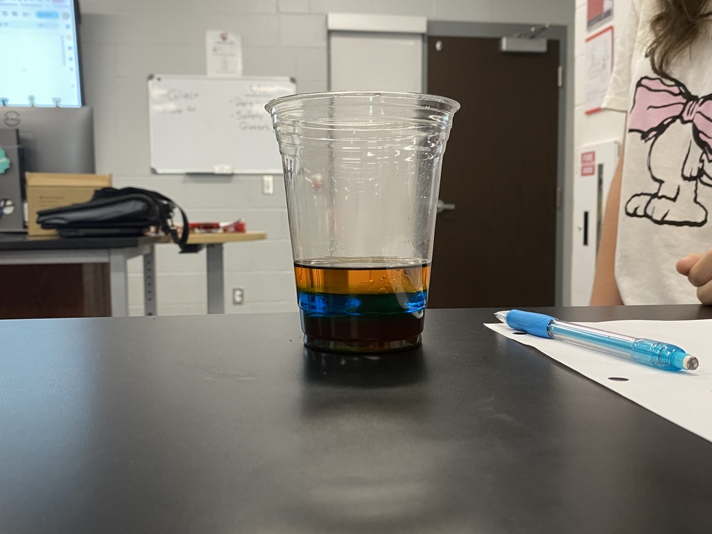 Cup showing layers of dense liquids