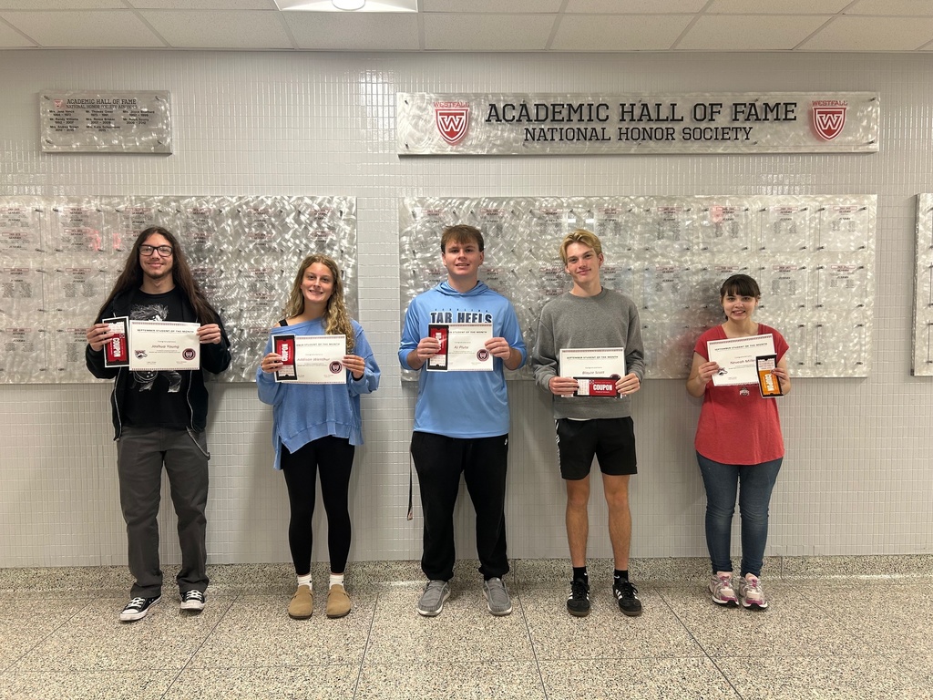 Students of the month holding certificates