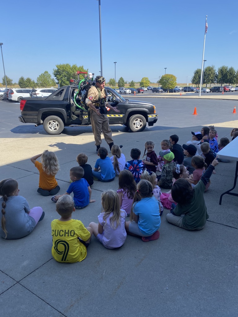Students listening to presentation from Ghostbuster