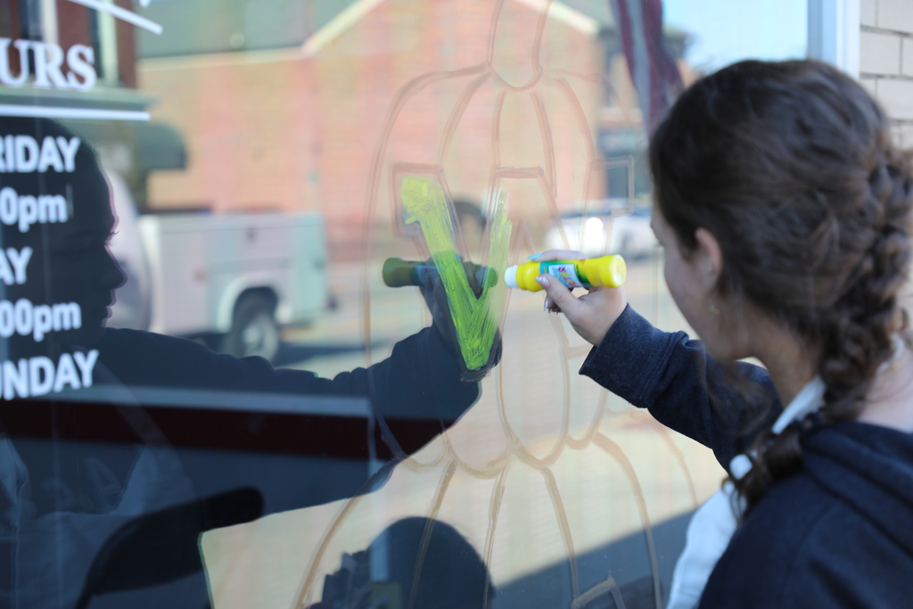 Student painting window