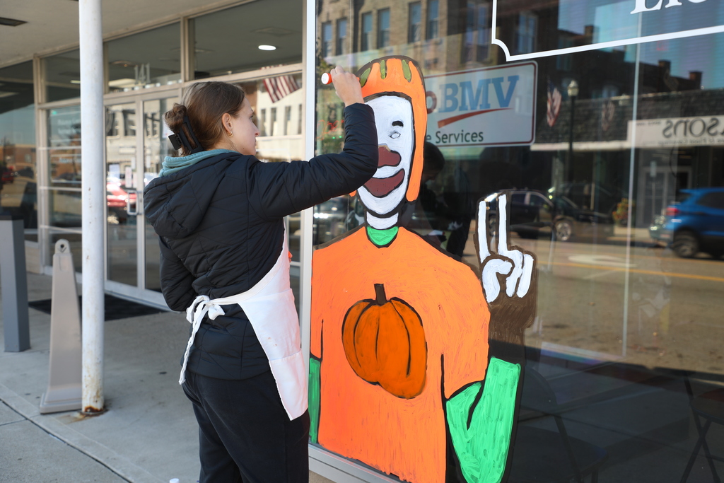Student painting window