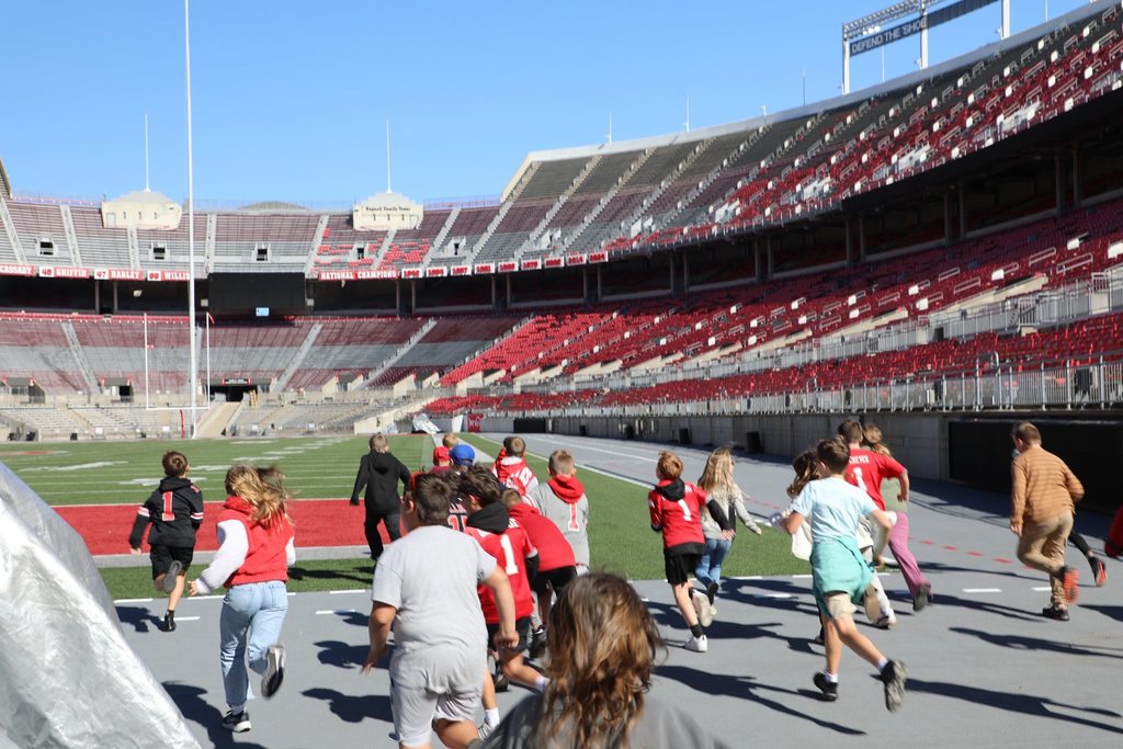 Students running onto the field