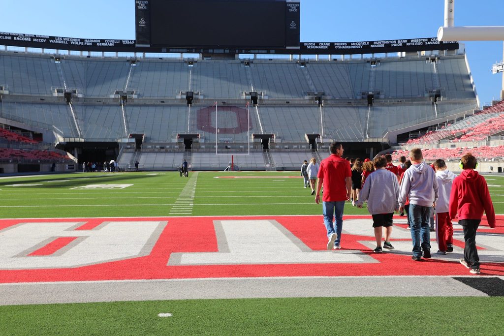Students walking out onto the field at Ohio Stadium