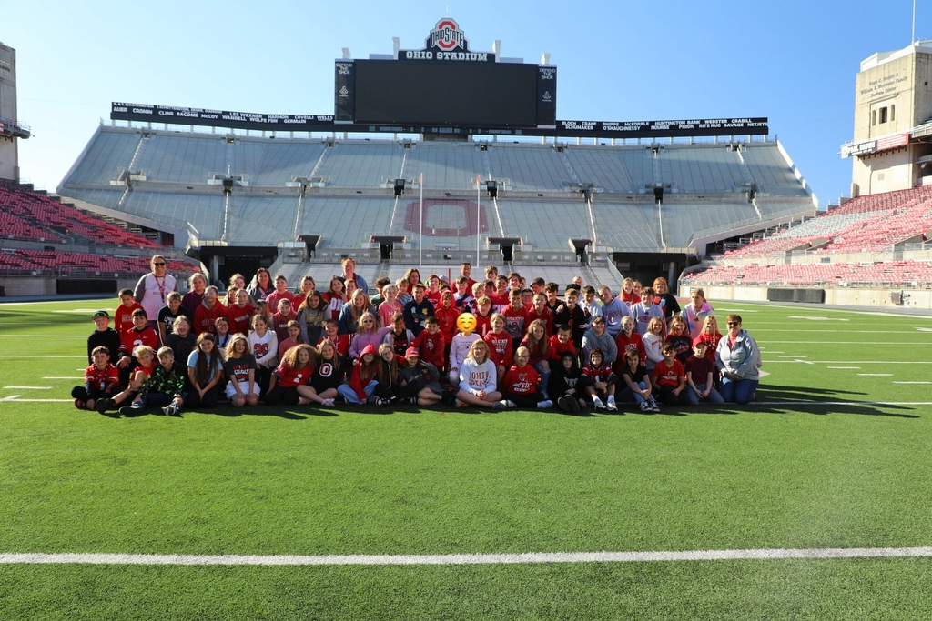 Group photo of students on the football field