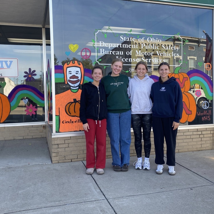 students standing in front of painted window