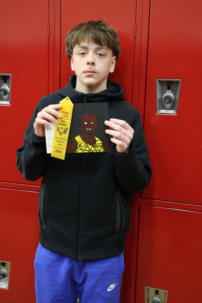 Photo of Raylen Fritz with artwork