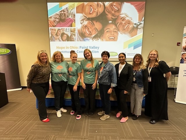 Group Photo in front of screen