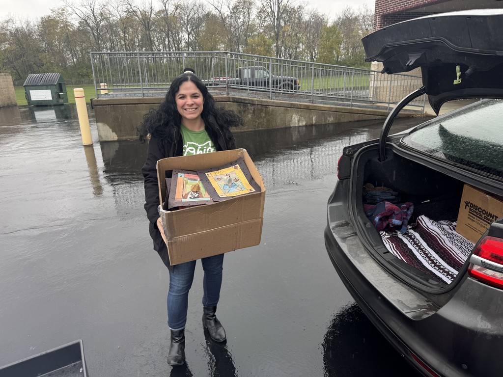 Employee from Ohio Environmental Agency holding box of artwork