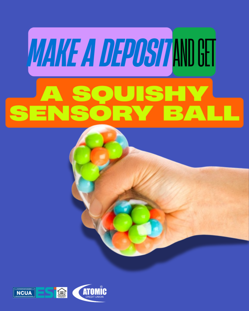hand squishing a clear sensory ball filled with smaller colorful balls