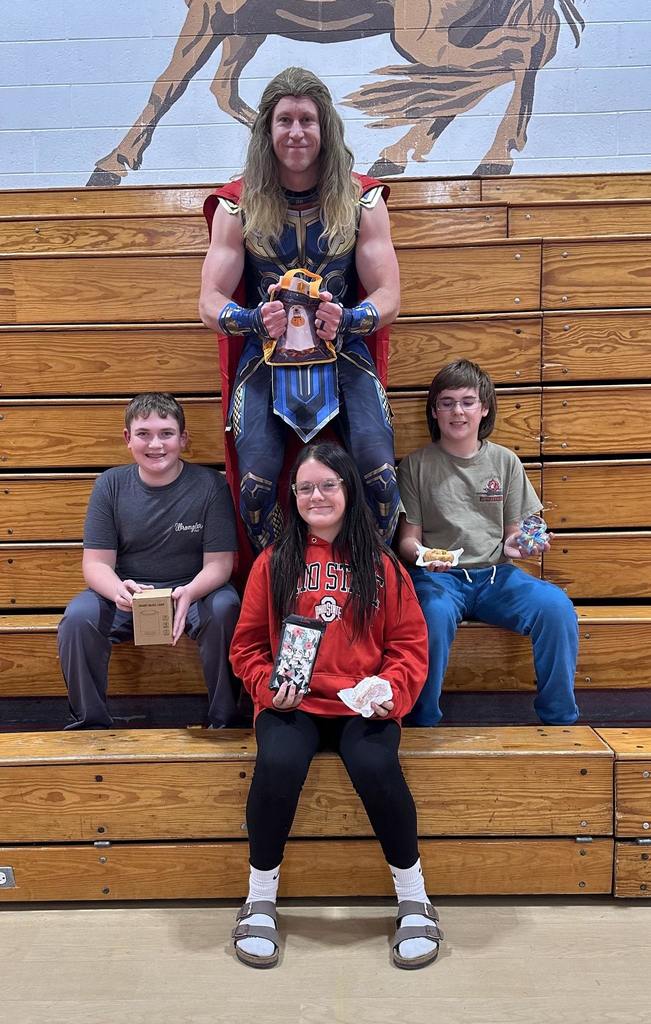 students and teachers holding treat bags