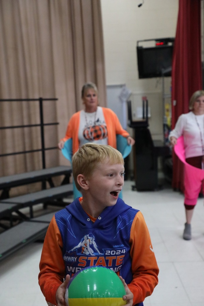 Student with inflatable beach ball with Mrs. Wolfe in the background