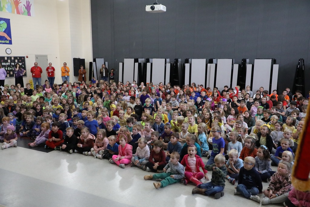 Student body in a rainbow of colored shirts