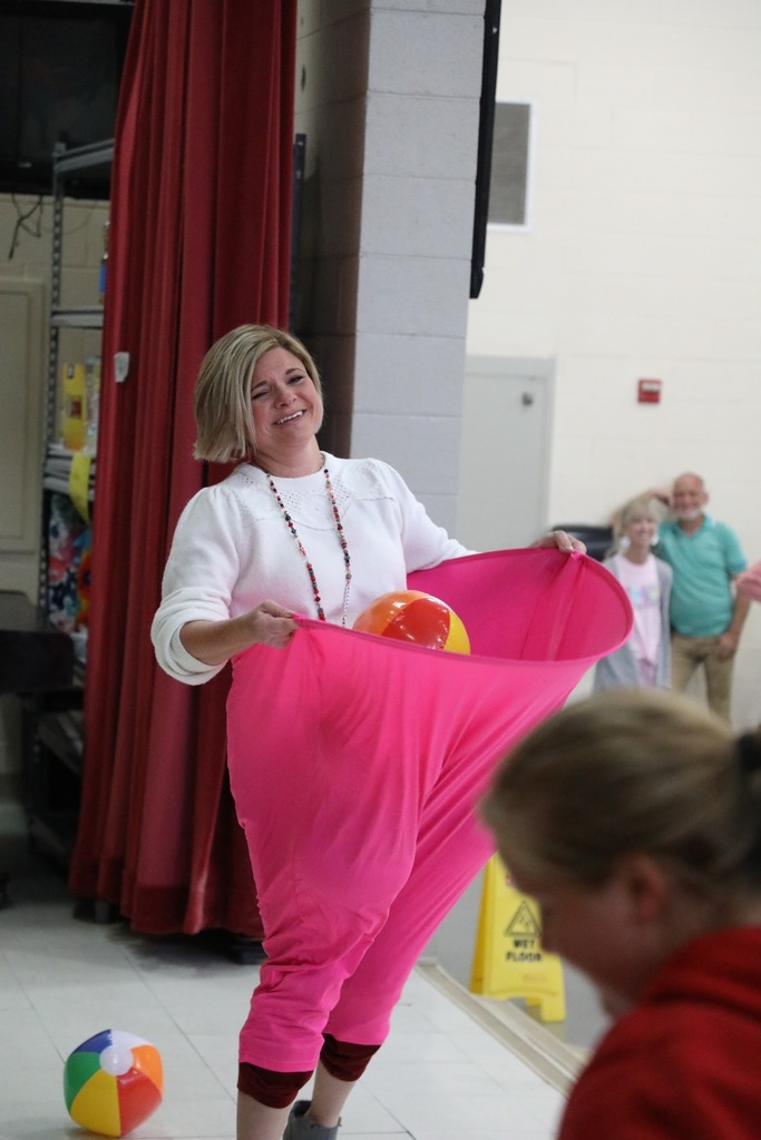 Mrs Patterson laughing with hoop pants and inflatable beach balls