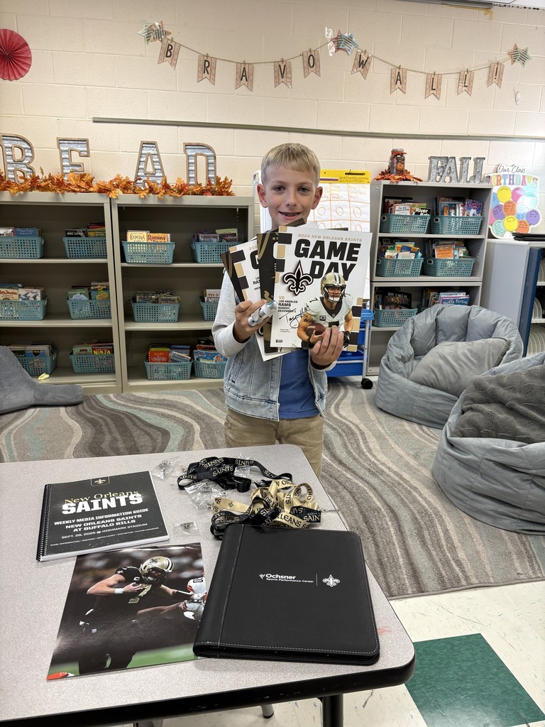 Student holding up free swag from New Orleans Saints